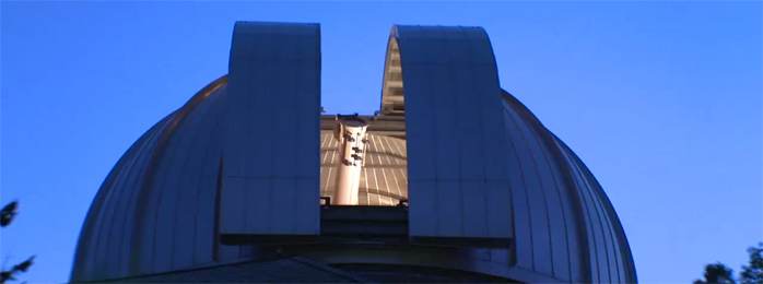 View of Dearborn Observatory dome with roof opening and telescope visible